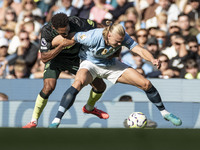 Erling Haaland #9 of Manchester City F.C. is tackled by the opponent during the Premier League match between Manchester City and Brentford a...