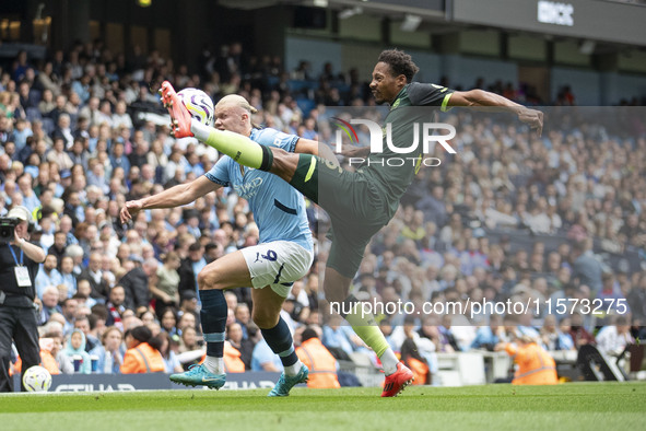 Erling Haaland #9 of Manchester City F.C. tackles Ethan Pinnock #5 of Brentford F.C. during the Premier League match between Manchester City...