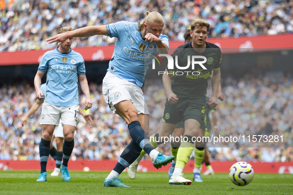 Erling Haaland #9 of Manchester City F.C. takes a shot at goal and scores during the Premier League match between Manchester City and Brentf...