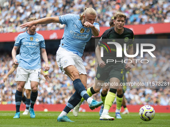 Erling Haaland #9 of Manchester City F.C. takes a shot at goal and scores during the Premier League match between Manchester City and Brentf...