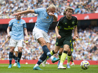 Erling Haaland #9 of Manchester City F.C. takes a shot at goal and scores during the Premier League match between Manchester City and Brentf...