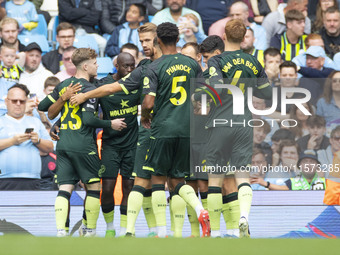 Brentford F.C. celebrate the goal during the Premier League match between Manchester City and Brentford at the Etihad Stadium in Manchester,...