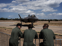 Three pilots look at an aircraft during the Athens Flying Show in Tanagra, Greece, on September 14, 2024. (