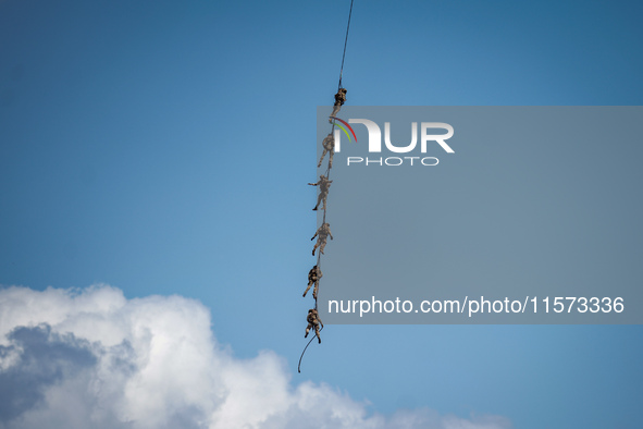 Members of the Greek Special Forces conduct demonstration exercises during the Athens Flying Show in Tanagra, Greece, on September 14, 2024 