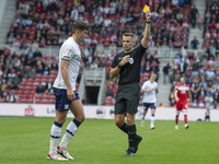 Referee Tom Nield shows Preston North End's Jordan Storey the yellow card during the Sky Bet Championship match between Middlesbrough and Pr...