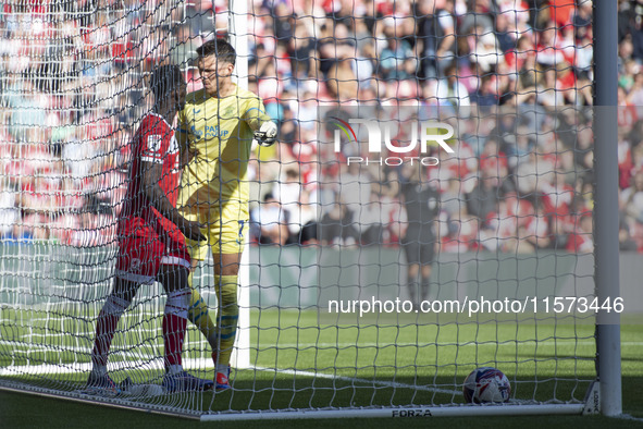 Preston North End goalkeeper Freddie Woodman clashes with Middlesbrough's Emmanuel Latte Lath during the Sky Bet Championship match between...