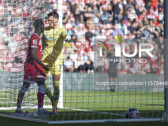 Preston North End goalkeeper Freddie Woodman clashes with Middlesbrough's Emmanuel Latte Lath during the Sky Bet Championship match between...