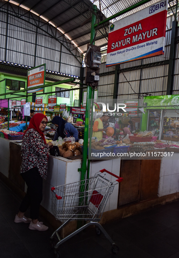 Activities of visitors and vegetable traders at Oro Oro Dowo traditional market in Malang, East Java, Indonesia, on September 14, 2024. This...