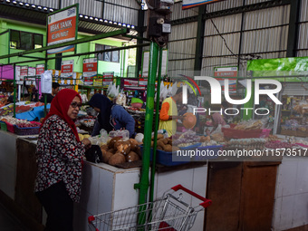 Activities of visitors and vegetable traders at Oro Oro Dowo traditional market in Malang, East Java, Indonesia, on September 14, 2024. This...