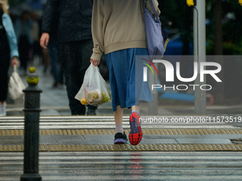 People with umbrellas are seen during a bout of rain in Warsaw, Poland on 14 September, 2024. Warnings for heavy rainfall and severe floodin...