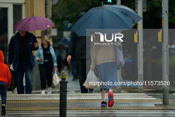 People with umbrellas are seen during a bout of rain in Warsaw, Poland on 14 September, 2024. Warnings for heavy rainfall and severe floodin...