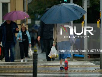 People with umbrellas are seen during a bout of rain in Warsaw, Poland on 14 September, 2024. Warnings for heavy rainfall and severe floodin...