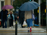 People with umbrellas are seen during a bout of rain in Warsaw, Poland on 14 September, 2024. Warnings for heavy rainfall and severe floodin...