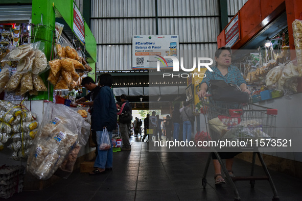 Activities of visitors and traders at Oro Oro Dowo traditional market in Malang, East Java, Indonesia, on September 14, 2024. This tradition...