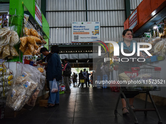 Activities of visitors and traders at Oro Oro Dowo traditional market in Malang, East Java, Indonesia, on September 14, 2024. This tradition...