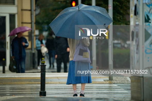 People with umbrellas are seen during a bout of rain in Warsaw, Poland on 14 September, 2024. Warnings for heavy rainfall and severe floodin...