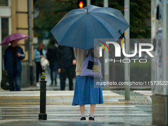 People with umbrellas are seen during a bout of rain in Warsaw, Poland on 14 September, 2024. Warnings for heavy rainfall and severe floodin...