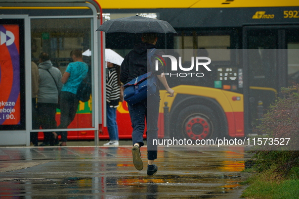 People with umbrellas are seen during a bout of rain in Warsaw, Poland on 14 September, 2024. Warnings for heavy rainfall and severe floodin...