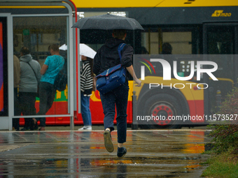 People with umbrellas are seen during a bout of rain in Warsaw, Poland on 14 September, 2024. Warnings for heavy rainfall and severe floodin...