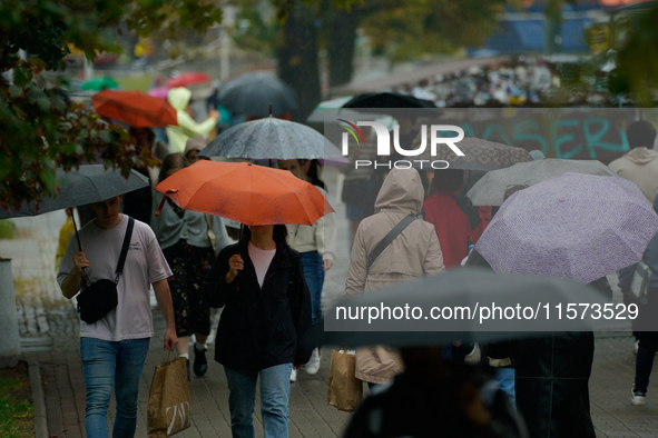 People with umbrellas are seen during a bout of rain in Warsaw, Poland on 14 September, 2024. Warnings for heavy rainfall and severe floodin...