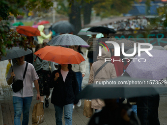 People with umbrellas are seen during a bout of rain in Warsaw, Poland on 14 September, 2024. Warnings for heavy rainfall and severe floodin...