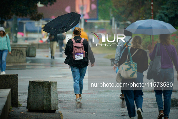 People with umbrellas are seen during a bout of rain in Warsaw, Poland on 14 September, 2024. Warnings for heavy rainfall and severe floodin...