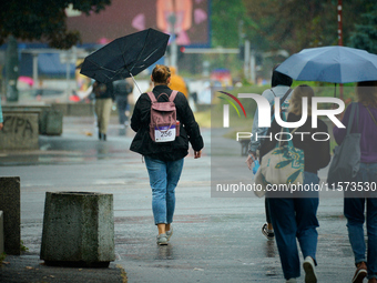 People with umbrellas are seen during a bout of rain in Warsaw, Poland on 14 September, 2024. Warnings for heavy rainfall and severe floodin...