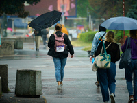 People with umbrellas are seen during a bout of rain in Warsaw, Poland on 14 September, 2024. Warnings for heavy rainfall and severe floodin...