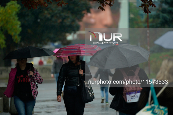 People with umbrellas are seen during a bout of rain in Warsaw, Poland on 14 September, 2024. Warnings for heavy rainfall and severe floodin...