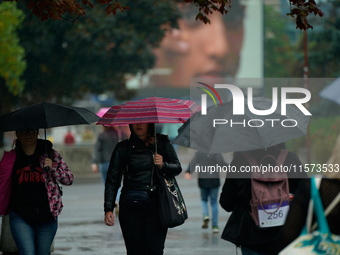 People with umbrellas are seen during a bout of rain in Warsaw, Poland on 14 September, 2024. Warnings for heavy rainfall and severe floodin...