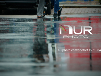 People with umbrellas are seen during a bout of rain in Warsaw, Poland on 14 September, 2024. Warnings for heavy rainfall and severe floodin...