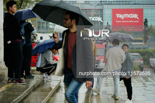 People with umbrellas are seen during a bout of rain in Warsaw, Poland on 14 September, 2024. Warnings for heavy rainfall and severe floodin...