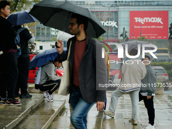 People with umbrellas are seen during a bout of rain in Warsaw, Poland on 14 September, 2024. Warnings for heavy rainfall and severe floodin...