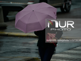 People with umbrellas are seen during a bout of rain in Warsaw, Poland on 14 September, 2024. Warnings for heavy rainfall and severe floodin...