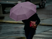 People with umbrellas are seen during a bout of rain in Warsaw, Poland on 14 September, 2024. Warnings for heavy rainfall and severe floodin...