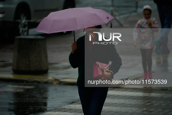 People with umbrellas are seen during a bout of rain in Warsaw, Poland on 14 September, 2024. Warnings for heavy rainfall and severe floodin...