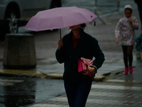 People with umbrellas are seen during a bout of rain in Warsaw, Poland on 14 September, 2024. Warnings for heavy rainfall and severe floodin...