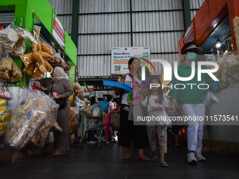 Activities of visitors and traders at Oro Oro Dowo traditional market in Malang, East Java, Indonesia, on September 14, 2024. This tradition...