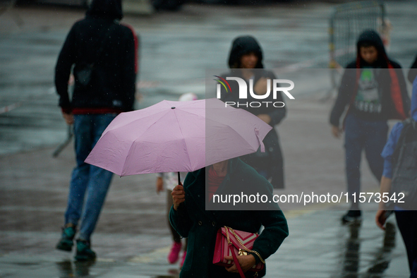 People with umbrellas are seen during a bout of rain in Warsaw, Poland on 14 September, 2024. Warnings for heavy rainfall and severe floodin...