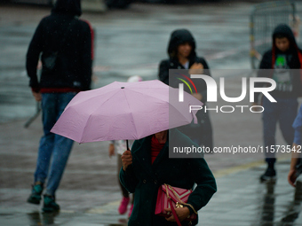 People with umbrellas are seen during a bout of rain in Warsaw, Poland on 14 September, 2024. Warnings for heavy rainfall and severe floodin...