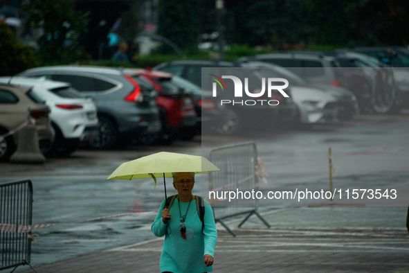 People with umbrellas are seen during a bout of rain in Warsaw, Poland on 14 September, 2024. Warnings for heavy rainfall and severe floodin...