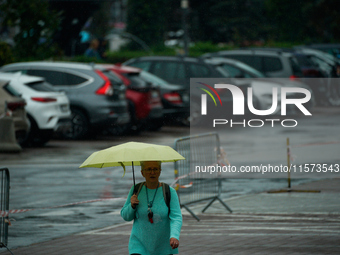 People with umbrellas are seen during a bout of rain in Warsaw, Poland on 14 September, 2024. Warnings for heavy rainfall and severe floodin...