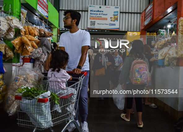 Activities of visitors and traders at Oro Oro Dowo traditional market in Malang, East Java, Indonesia, on September 14, 2024. This tradition...