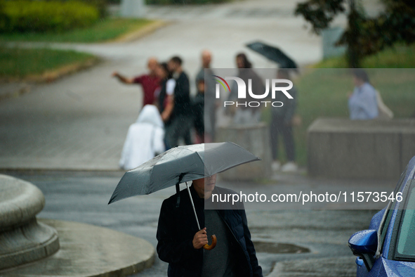 People with umbrellas are seen during a bout of rain in Warsaw, Poland on 14 September, 2024. Warnings for heavy rainfall and severe floodin...