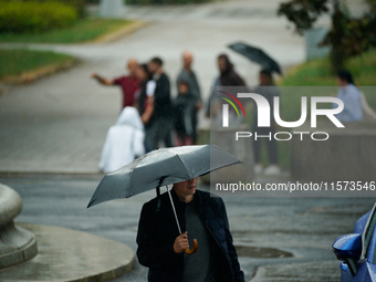 People with umbrellas are seen during a bout of rain in Warsaw, Poland on 14 September, 2024. Warnings for heavy rainfall and severe floodin...