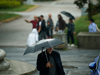 People with umbrellas are seen during a bout of rain in Warsaw, Poland on 14 September, 2024. Warnings for heavy rainfall and severe floodin...