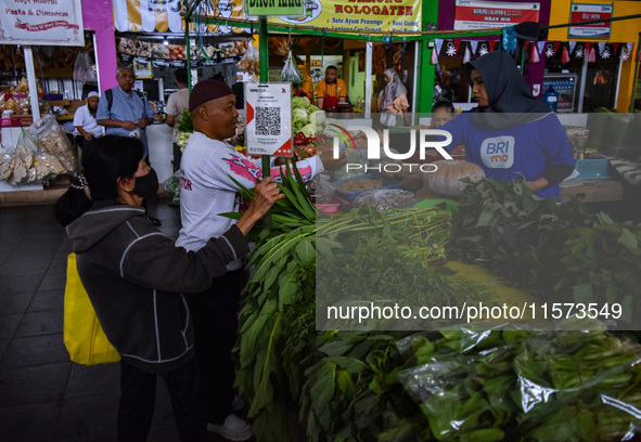 Activities of visitors and vegetable traders at Oro Oro Dowo traditional market in Malang, East Java, Indonesia, on September 14, 2024. This...