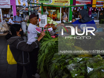 Activities of visitors and vegetable traders at Oro Oro Dowo traditional market in Malang, East Java, Indonesia, on September 14, 2024. This...