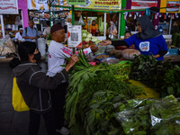 Activities of visitors and vegetable traders at Oro Oro Dowo traditional market in Malang, East Java, Indonesia, on September 14, 2024. This...