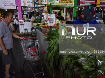 Activities of visitors and vegetable traders at Oro Oro Dowo traditional market in Malang, East Java, Indonesia, on September 14, 2024. This...